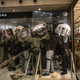Riot police shelter against a wall as protesters throw objects at them after they chased protesters through a shopping mall on July 14, 2019 in Hong Kong.